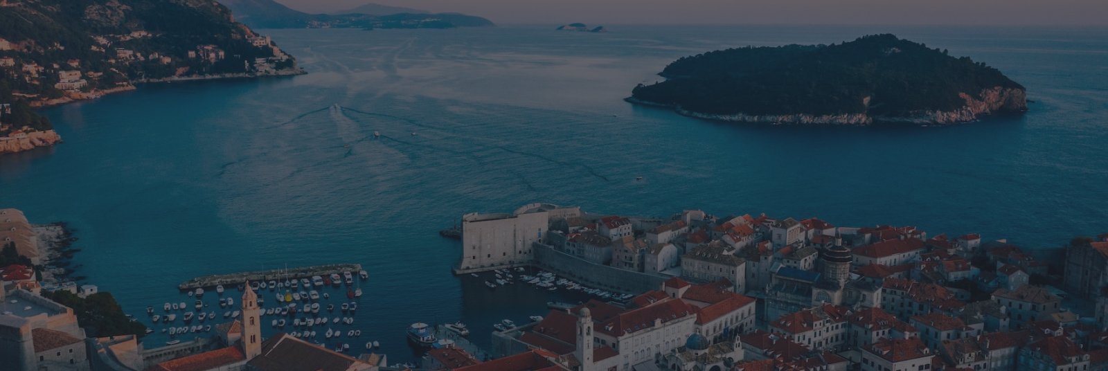 Terracotta rooftops and turquoise coastal waters in Dubrovnik, Croatia